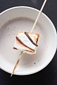 Cocoa with marshmallow on stick for Halloween