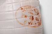Rolled joint of pork with stamp (close-up)
