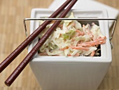 Coleslaw (cabbage salad, USA) in white container with chopsticks