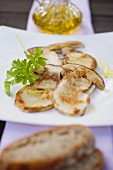 Fried cep slices with parsley, olive oil and bread