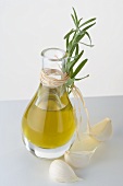 Olive oil in carafe, garlic and fresh rosemary