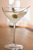 Martini with olive on cocktail stick