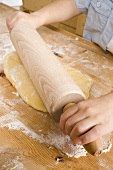 Child rolling out dough
