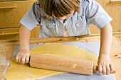 Child rolling out dough