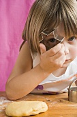 Child peeping through a biscuit cutter