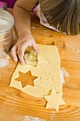 Child cutting out biscuits (overhead view)
