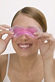 Woman with a cooling eye mask