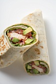 Two wraps filled with chicken and avocado