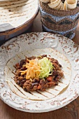 Mince and bean filling with cheese on tortilla