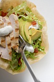 Tortilla shell filled with chicken breast, avocado & sour cream