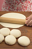 Woman rolling out tortilla dough