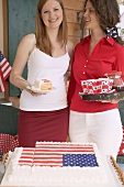Two women with cake and coffee on the 4th of July (USA)