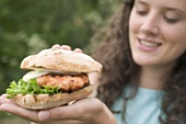 Woman holding chicken burger