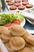Hamburger buns, salad and burgers