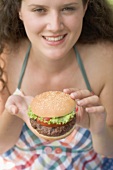Woman holding hamburger