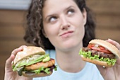 Woman with two different burgers