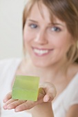 Woman holding green soap