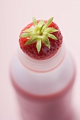 Strawberry drink in plastic bottle (overhead view)