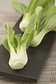 Fresh pak choi on chopping board