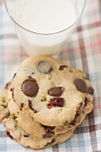 Chocolate chip cookies with cranberries, glass of milk