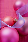 Pink Christmas baubles with blue ribbon