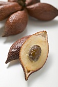 Several salak fruits, whole and halved