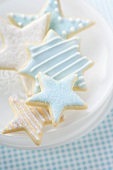 Star biscuits with blue and white icing on plate