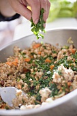 Sprinkling parsley into bread stuffing