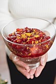 Woman holding bowl of cranberry sauce