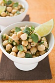 Chick-peas with lime wedges and herbs