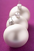 Three silver Christmas baubles