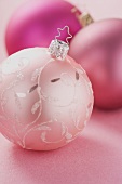 Three different pink Christmas baubles