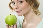 Woman holding green apple