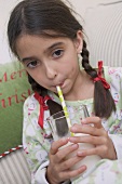 Girl drinking milk through straw