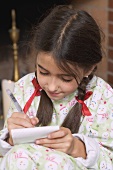 Girl writing her Christmas wish list
