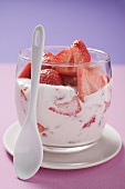 Strawberry quark in glass, spoon in front