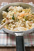 Pan-cooked rice and fish dish with lemon zest (detail)
