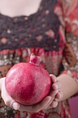 Woman holding pomegranate