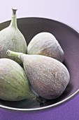 Four fresh figs in bowl (detail)