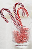 Candy canes and sugar stars in glass
