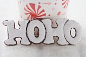 Christmas biscuit (the word HOHO) in front of cup