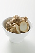 Fresh ginger roots in bowl