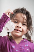 Small girl holding Christmas bauble