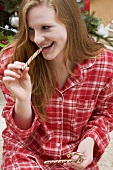 Woman eating candy cane