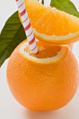 Orange with straw and wedge of orange