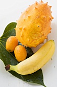 Banana, kiwano and kumquats on leaf