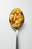 Pumpkin seeds on spoon (overhead view)