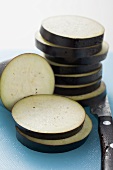 Aubergine slices on chopping board