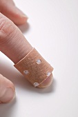 Finger with sticking plaster