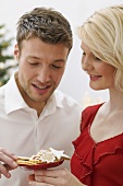 Woman offering man Christmas biscuits